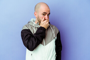 Young caucasian bald man isolated on purple background scared and afraid.