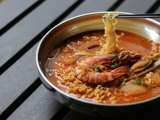 Kimchi Ramyeon, Seafood Ramen, Korean Instant noodle. Spicy Korean Noodle Soup. Kimchi Ramen on Stainless Steel Bowl.