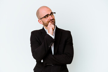 Young business caucasian bald man isolated on blue background thinking and looking up, being...