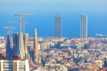 Naklejka premium Awesome Barcelona Cityscape . Gracia Famous catalonian district in Barcelona . Cathedral with construction cranes 