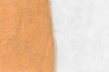 Wall two colors: light brown and white paint on concrete surface texture background