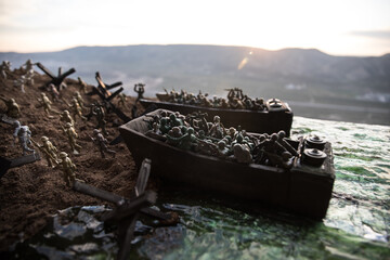 World War 2 reenactment (D-day). Creative decoration with toy soldiers, landing crafts and hedgehogs. Battle scene of Normandy landing on June 6, 1944. - obrazy, fototapety, plakaty