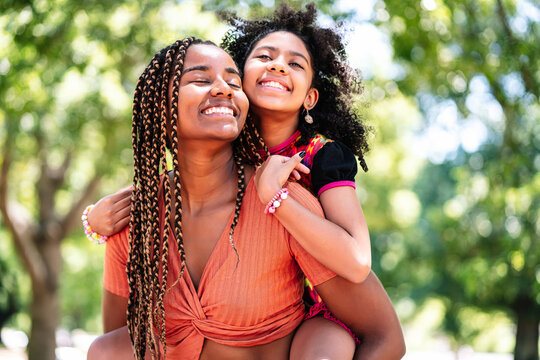 Mother and daughter enjoying a day at the park.