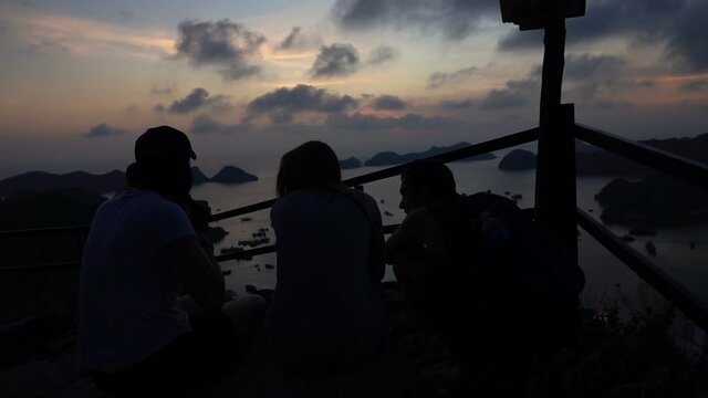 Friends admire amazing view over bay at Ha Long Bay in Vietnam, slow motion