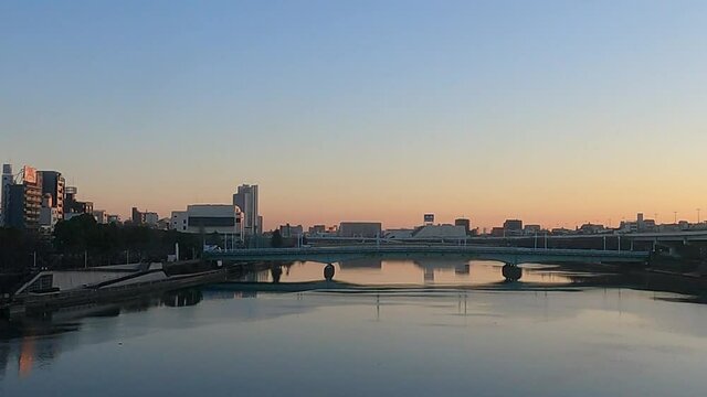A railroad car window that crosses the river in the early morning. Near Sumida River, Tokyo