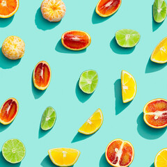 Colorful fruit pattern from fresh citrus, lemon, red orange, tangerine and lime on blue background. Summer food.