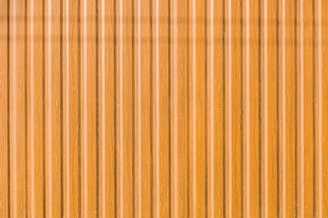 Light brown or orange metal fence surface with abstract wood coating wall texture background