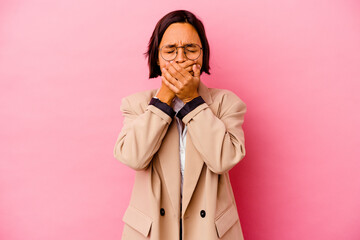 Young business mixed race woman isolated on pink background suffers pain in throat due a virus or...