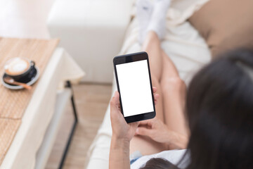 Close up hands of woman using mobile phone, cell phone in coffee shop. Hands of women holding blank empty screen smart phone in cafe. Women relax with mobile phone sit in restaurant