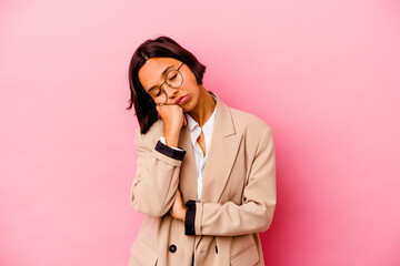 Young business mixed race woman isolated on pink background who is bored, fatigued and need a relax day.