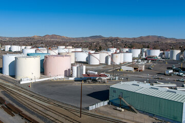 Fototapeta na wymiar Aerial view of a Petroleum fuel storage tank farm near some railroad tracks.