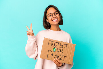 Fototapeta na wymiar Young hispanic mixed race woman holding a protect our planet cardboard showing number two with fingers.
