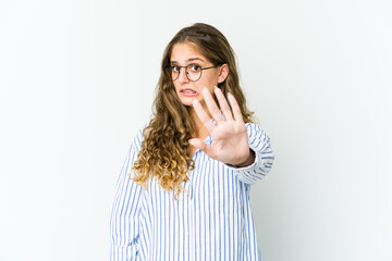 Young caucasian woman rejecting someone showing a gesture of disgust.