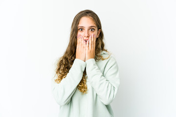 Young caucasian woman shocked, covering mouth with hands, anxious to discover something new.