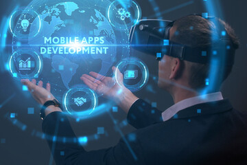 Business, Technology, Internet and network concept. Young businessman working on a virtual screen of the future and sees the inscription: Mobile apps development