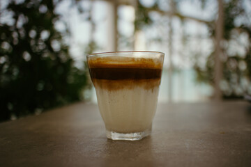 Close up of a cup of coffee on the table in the cafe.