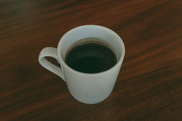Close up of a cup of coffee on the table in the cafe.