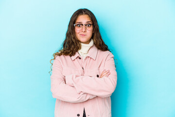 Fototapeta premium Young caucasian curly hair woman isolated blows cheeks, has tired expression. Facial expression concept.