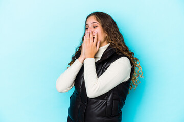 Young caucasian curly hair woman isolated laughing about something, covering mouth with hands.