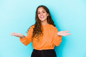 Young caucasian curly hair woman isolated makes scale with arms, feels happy and confident.