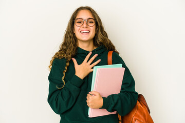 Young caucasian student woman isolated laughs out loudly keeping hand on chest.