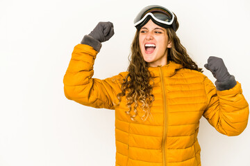 Young caucasian snowboarder woman isolated raising fist after a victory, winner concept.