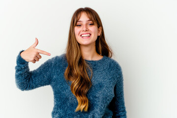 Young caucasian cute woman isolated on white background person pointing by hand to a shirt copy space, proud and confident