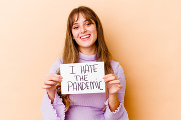 Fototapeta na wymiar Young caucasian woman holding a I hate the pandemic placard isolated happy, smiling and cheerful.