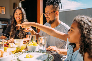 Happy latinx family having breakfast at home