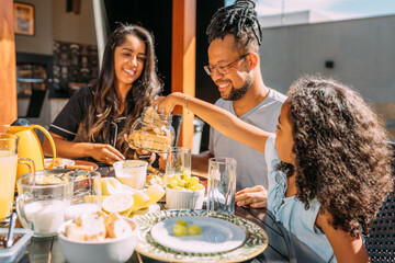 Happy latinx family having breakfast at home
