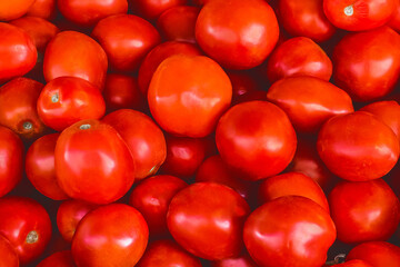 Heap of red Ukrainian tomatoes background on the market