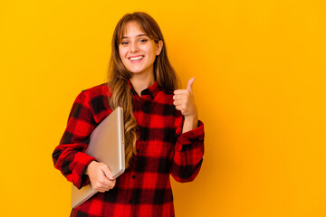 Young caucasian woman holding a laptop isolated smiling and raising thumb up