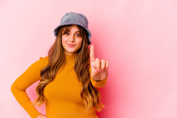 Young caucasian woman wearing fishermans hat isolated showing number one with finger.