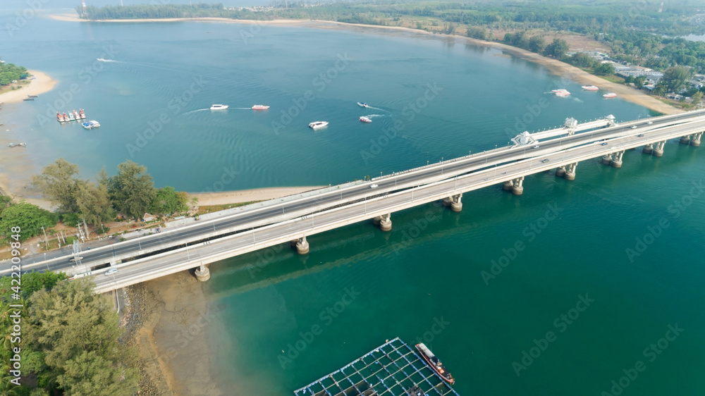 Wall mural aerial top view drone shot of bridge with cars on bridge road image transportation background concep