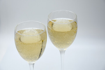 Glasses of champagne on white background