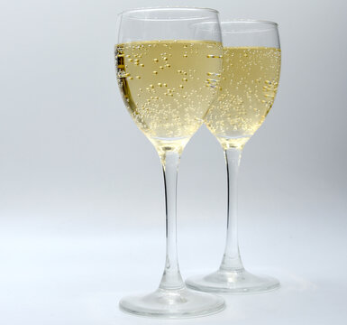 Champagne in transparent glasses on white table
