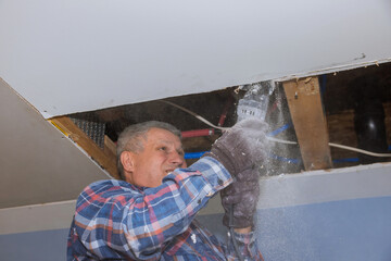 Improvement renovation apartment interior damage for drywall board with repair home of man cutting...
