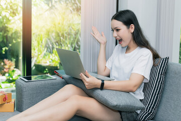 Successful entrepreneur business woman with online sales and Parcel shipping in her home office. Woman checking order on laptop.