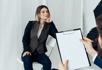 Woman for job interview and man with documents in the foreground