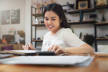 Young asian woman in smart casual wear working in home office. Social distance practice prevent coronavirus COVID-19.