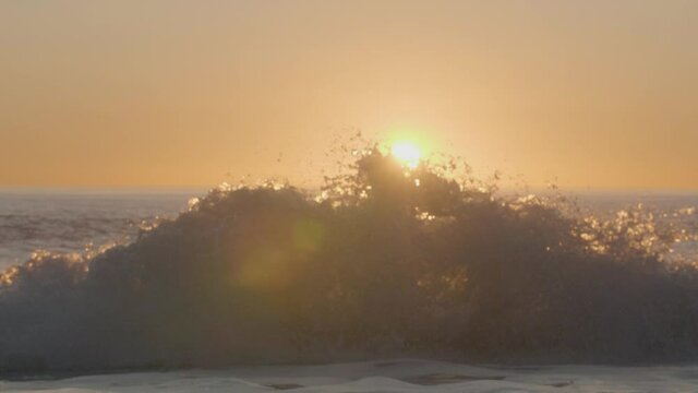 Ocean wave exploding erupting with sunset sunrise horizon