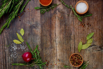Aromatic dry herbs and spices on wooden table.