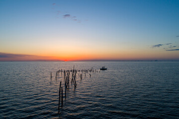 Boat on Mobile bay at sunset 