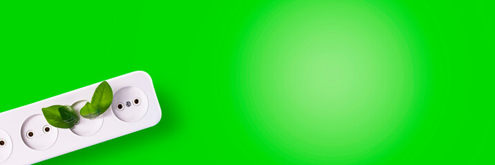 A tree growing from a rosette on a green background with a place for text. Green clean energy, save the world