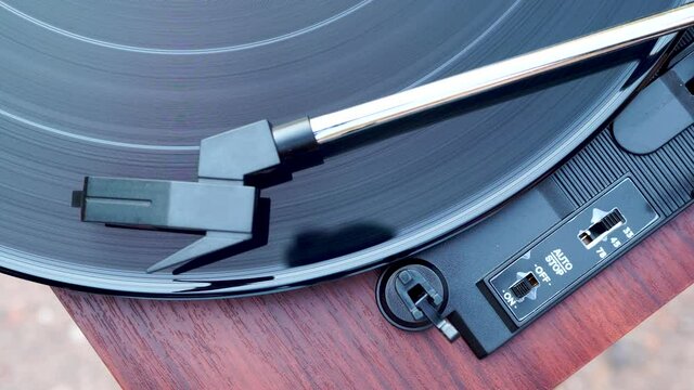 Top view of Turntable is spinning with a phono cartridge on the Vinyl. Vintage music player.