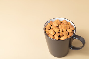Brown almond in a coffee mug with copy space.