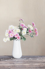 chrysanthemums in  vase on old wooden table