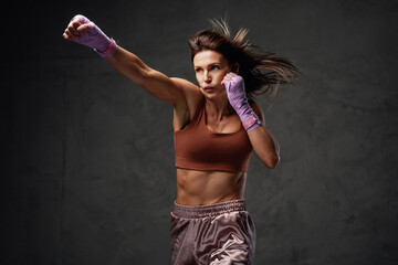 Fototapeta na wymiar Handsome and strong woman punches doing physical exercise