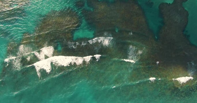 Crystal clear tropical waters of Porto de Galinhas. Aerial drone shot, birds eye view, truck shot right.