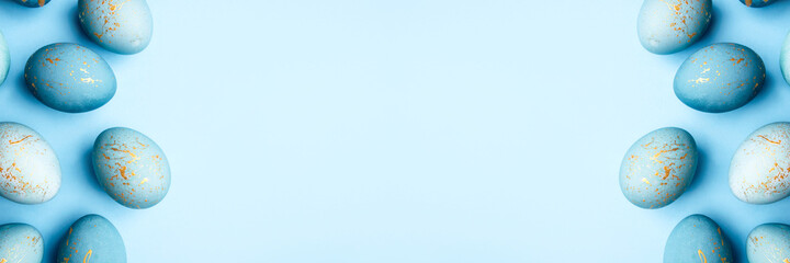 Easter frame of eggs painted in blue color. Flat lay, top view. Copy space for text.
